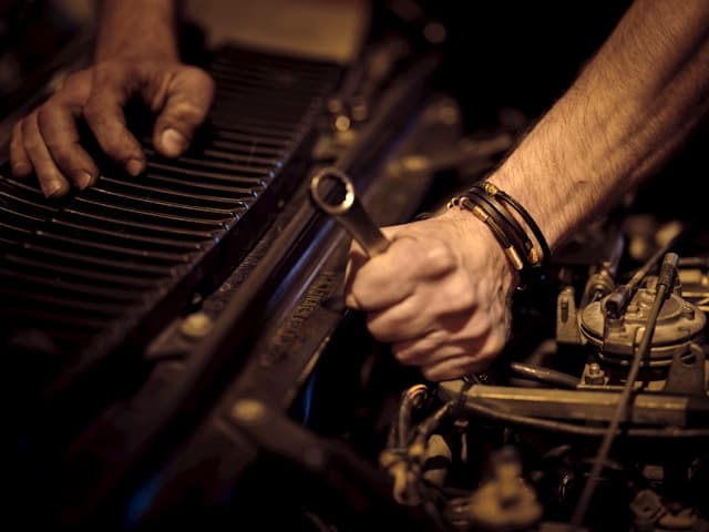 Mechanic working on a 4WD engine bay